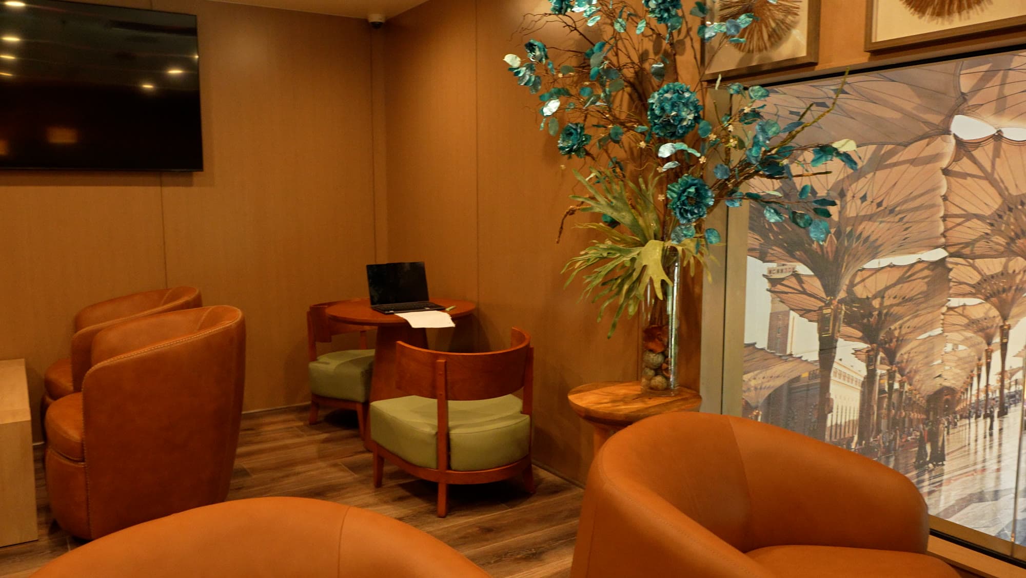 The Lounge at Escape 360 Carrollton — sofas, lounge chairs, and warm greenery
