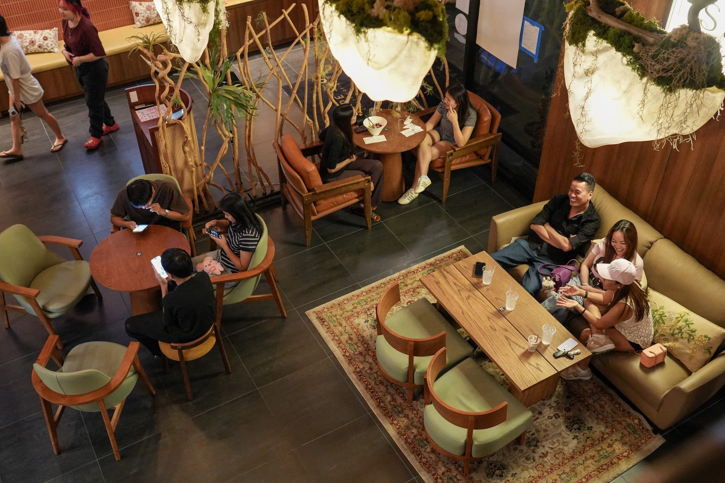 Escape 360 Carrollton — glowing moss-pod lanterns over the lounge seating