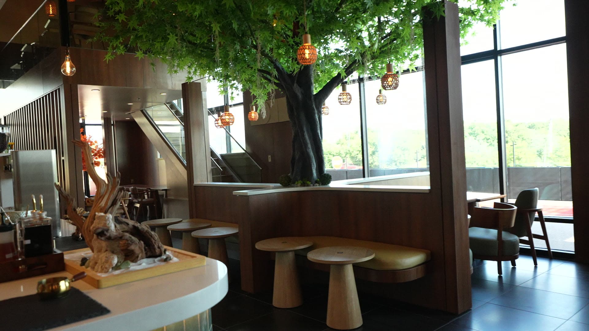 The central tree rising from the banquette at Escape 360 Carrollton