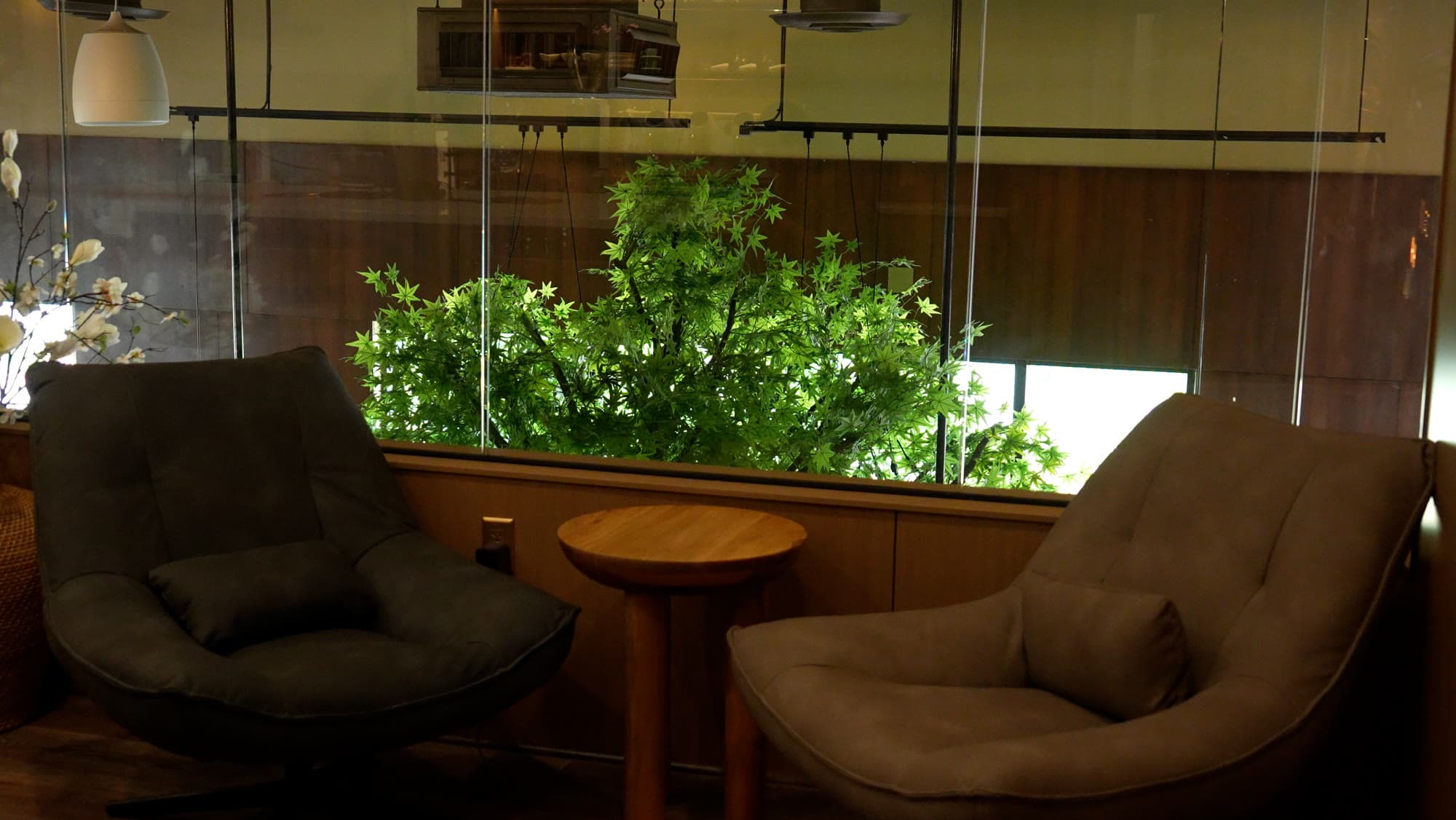 Warm lounge seating and greenery on the upper floor at Escape 360 Carrollton