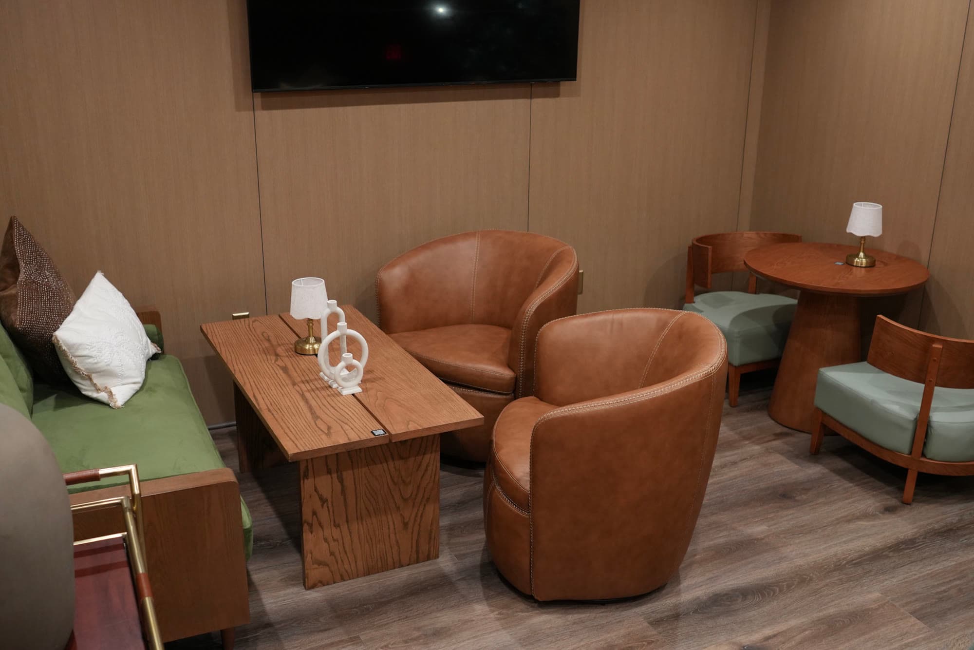 The mounted TV and additional seating in the Private Lounge Room