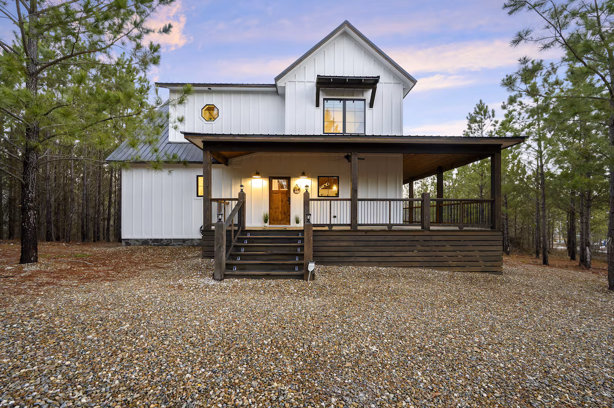 The Escape 360 Retreat cabin — modern farmhouse exterior with wraparound porch