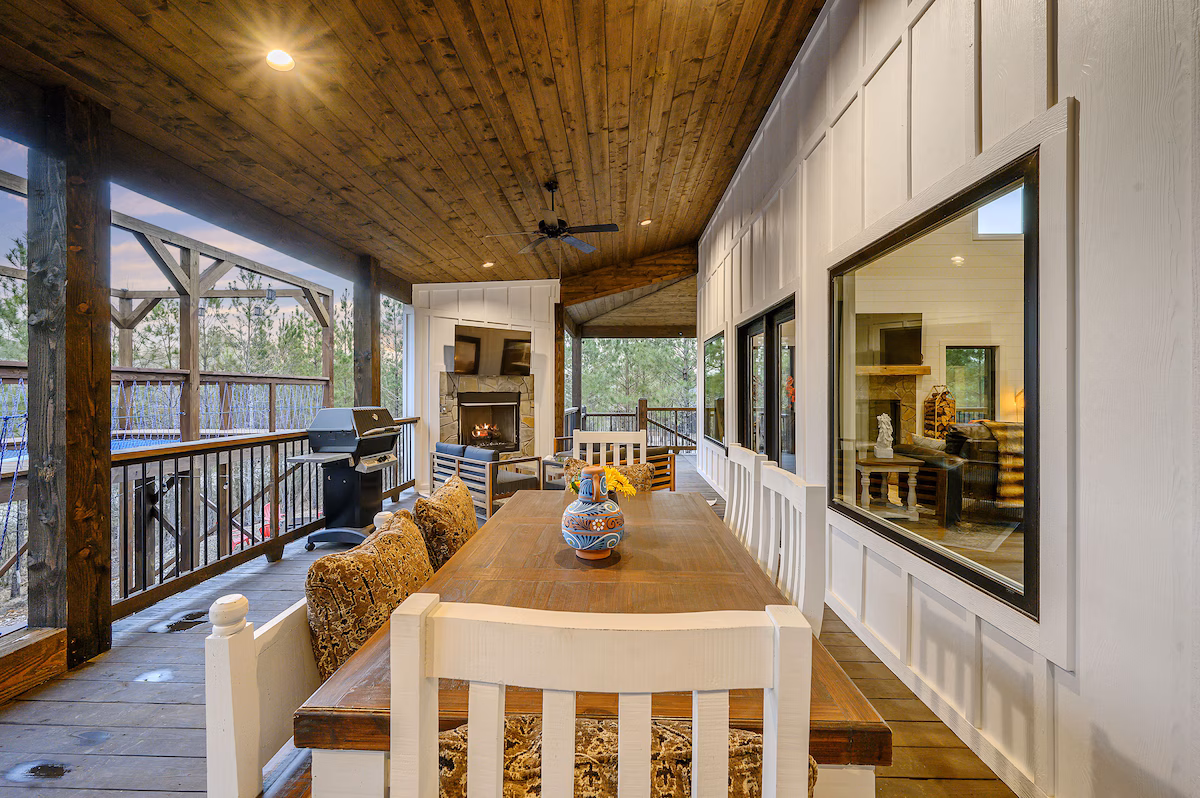 Covered outdoor dining with fireplace and grill